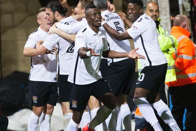 ON TARGET AGAIN - the Cobblers players celebrate John-Joe O'Toole's headed goal in the 3-1 win at Swindon Town on Tuesday (Picture: Kirsty Edmonds)
