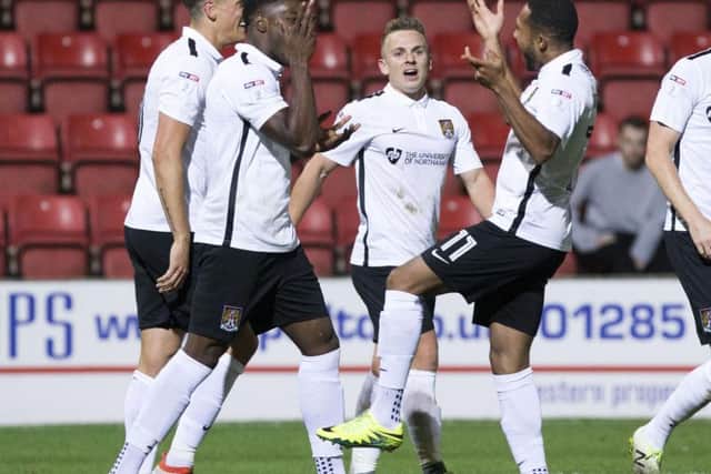 JJ Hooper and Kenji Gorre celebrate the Cobblers' third goal at Swindon on Tuesday