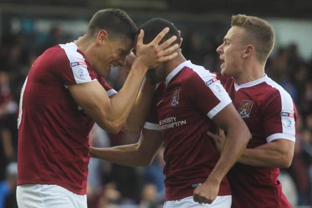 Alex Revell and Kenji Gorre celebrate after Northampton draw level at 2-2. Pictures: Sharon Lucey