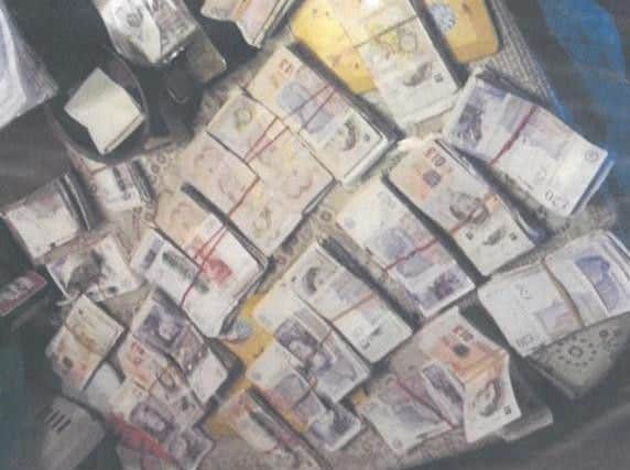 Bundles of cash were seized from various safe houses, totalling 85,000.