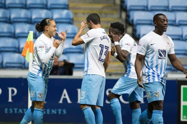 Coventry players celebrate their second goal against the Cobblers