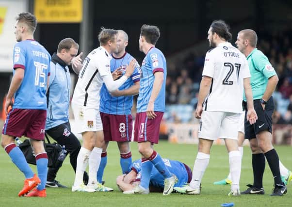 Matt Taylor protests his innocence to referee Darren Handley at Scunthorpe on Saturday (Picture: Kirsty Edmonds)