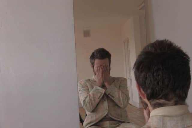Olive Sanderson confronting his reflection for the first time in 16 months.
