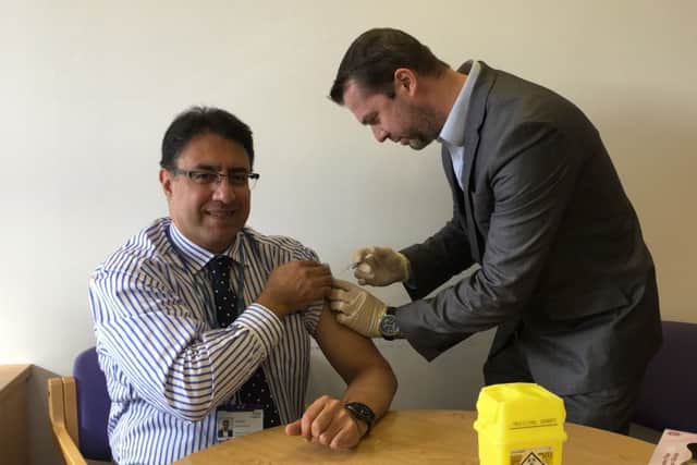NHS Medical director, Northamptonshire Aly Rashid has his flu jab