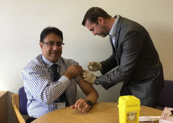 NHS Medical director, Northamptonshire Aly Rashid  has his flu jab