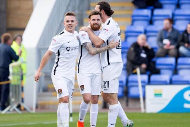 TWO TO THE GOOD: Cobblers celebrate Paul Anderson's goal that put them into a 2-0 lead at Shrewsbury. Picture by Kirsty Edmonds