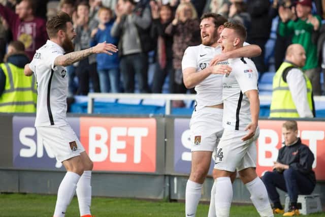 HAPPY LADS - Paul Anderson (left) and Jak McCourt help Sam Hoskins (right) celebrate his goal in Saturday's 4-2 win at Shrewsbury (Picture: Kirsty Edmonds)