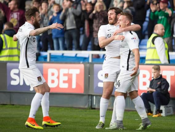 HAPPY LADS - Paul Anderson (left) and Jak McCourt help Sam Hoskins (right) celebrate his goal in Saturday's 4-2 win at Shrewsbury (Picture: Kirsty Edmonds)