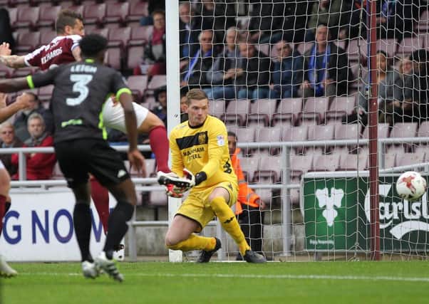 BREAKING THE DEADLOCK - Marc Richards pokes home the Cobblers' first goal in the win over Bury (Pictures: Sharon Lucey)