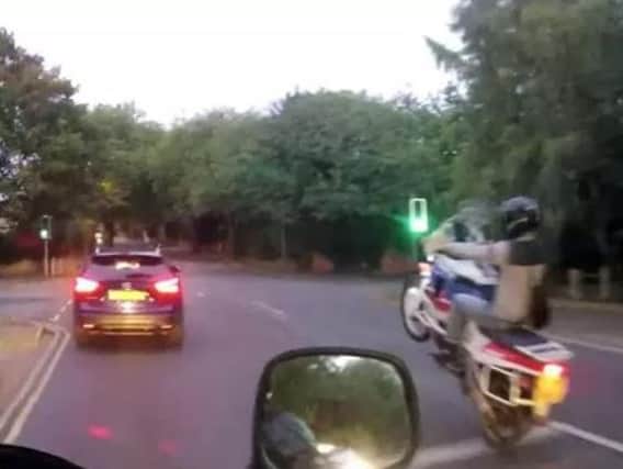 A bike thief pulls a wheelie as he speeds away from the lights in Northampton.
