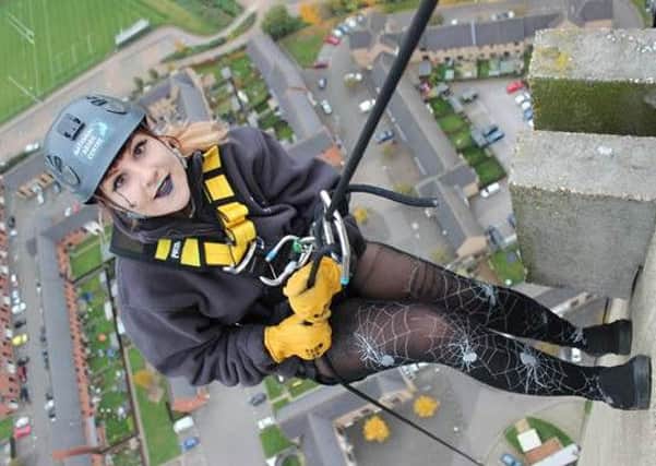 Keely Warren, Marketing Assitant abseiling the tower