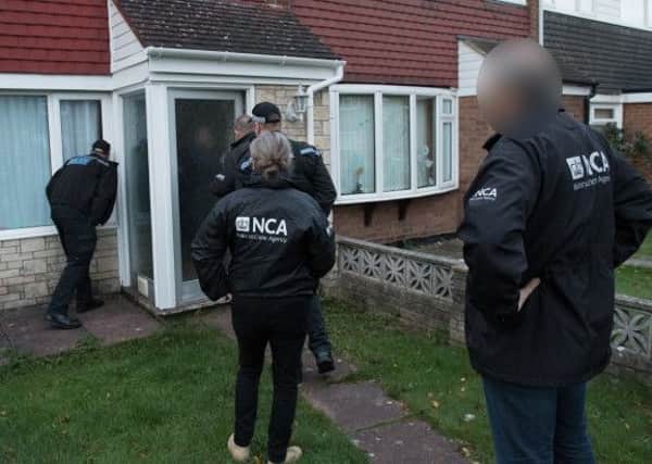 Officers from Northamptonshire Police and the National Crime Agency in Daventry. Photo from Northants Police.