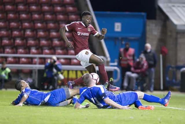 JJ Hooper eludes two Harrow defenders to score Town's sixth and his first goal for the club