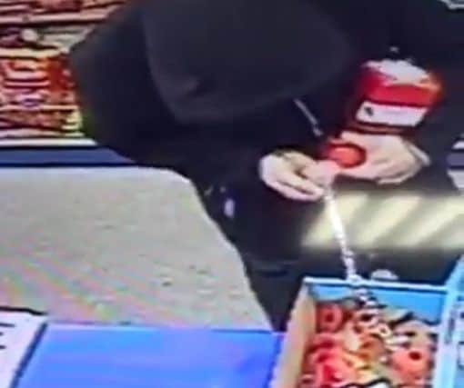 Alleged thief caught on CCTV in the Costcutter store on Weedon Road taking poppy appeal box