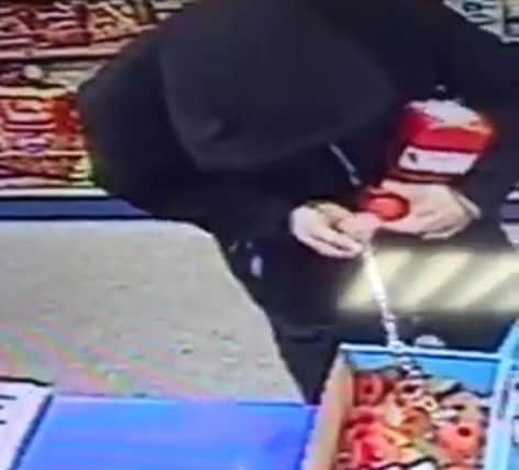 Alleged thief caught on CCTV in the Costcutter store on Weedon Road taking poppy appeal box
