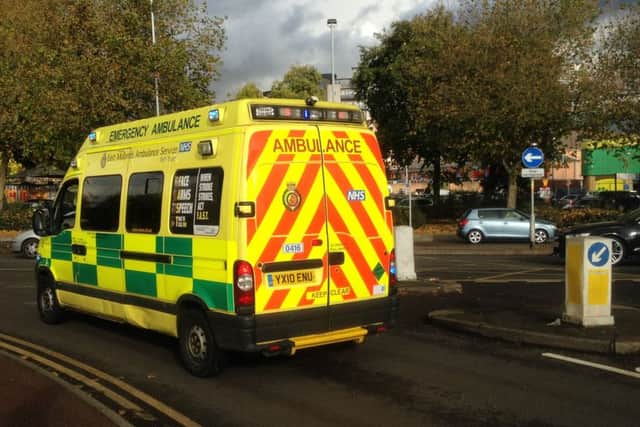 An ambulance leaves the Carlsberg factory in Northampton.