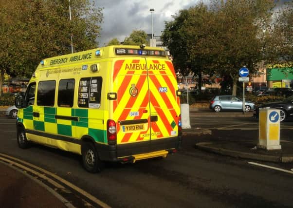 An ambulance leaves the Carlsberg factory in Northampton.