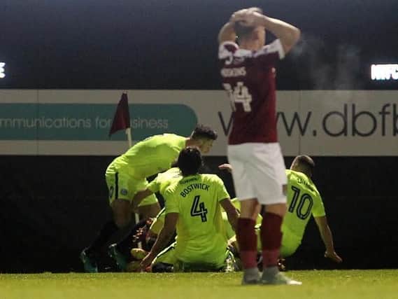 HEARTBREAK - the Peterborough players celebrate their late winner at Sixfields (Pictures: Sharon Lucey)
