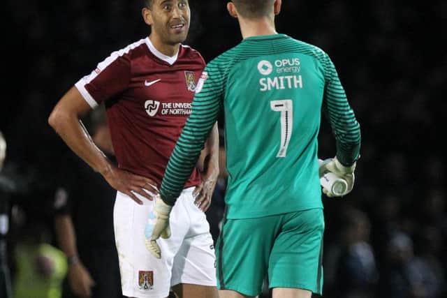 Lewin Nyatanga and Adam Smith discuss Peterborough's last-gasp winner at Sixfields on Saturday (Pictures: Sharon Lucey)