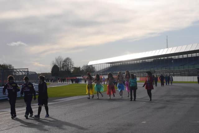 Students from Silverstone UTC make their way around the world famous circuit