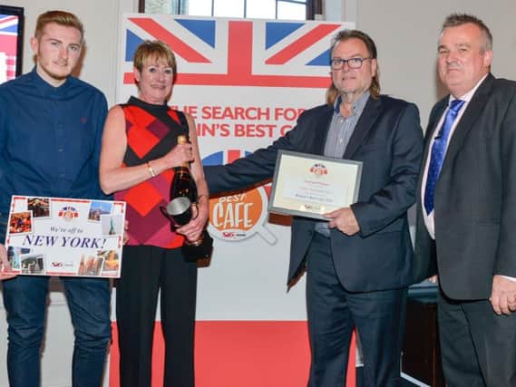 SIG Roofing's managing director Andrew Wakelin presents the Britain's Best Cafe national winner award to the Super Sausage team. Left to right, Simon, Gail and Chris Murray and Andrew Wakelin