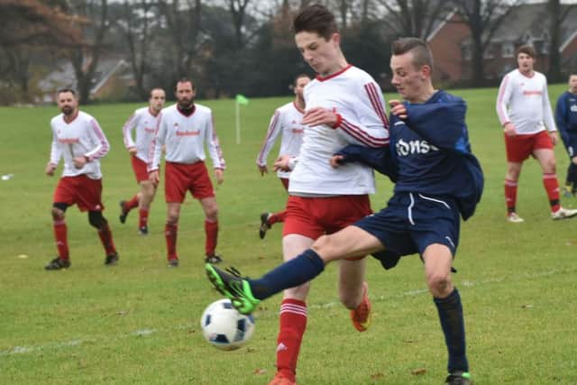 OUTNUMBERED - action from FC Squizzas clash with The District (Pictures: Dave Ikin)