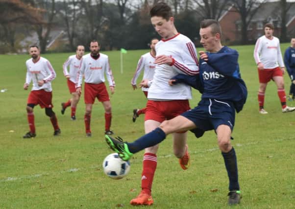 OUTNUMBERED - action from FC Squizzas clash with The District (Pictures: Dave Ikin)