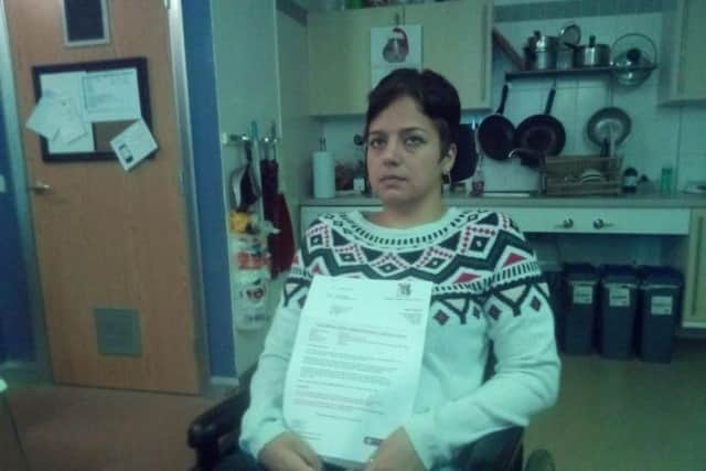 Roxanne with the County Council's legal letter demanding 8,000