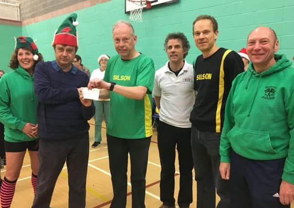 Silson AC presented DISC with a cheque for Â£300. DISC stands for Disability Inclusive Sports Club