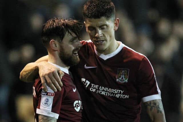 TEAM-WORK - Alex Revell celebrates with Paul Anderson after the latter had prodded hom the Cobblers' third goal at Port Vale, pouncing to score after the goalkeeper had saved Revell's shot