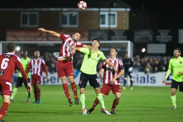 Alex Revell challenges for the ball at Stourbridge