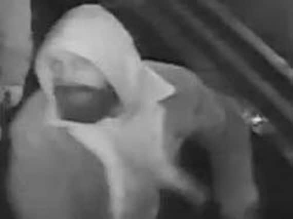 Police want to trace this bearded man in relation to the vandalism of a Northampton business.