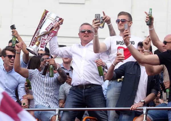 HAPPY MEMORIES - Chris Wilder leads the Cobblers' celebrations on the open top bus parade in May