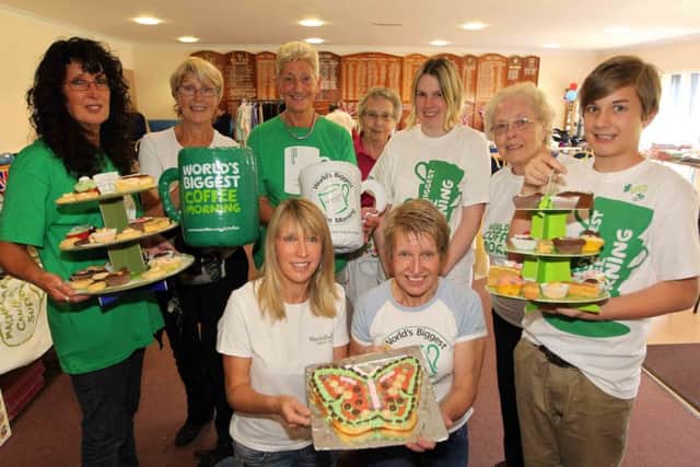 Iris Sharman (back, centre) pictured volunteering at a coffee morning in 2012.