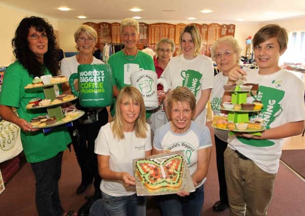 Iris Sharman (back, centre) pictured volunteering at a coffee morning in 2012.