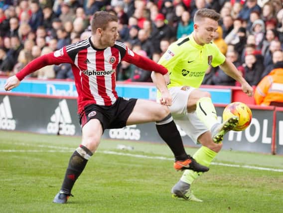 Sam Hoskins battles for the ball during the Cobblers' 1-0 defeat at Sheffield United (Pictures: Kirsty Edmonds)