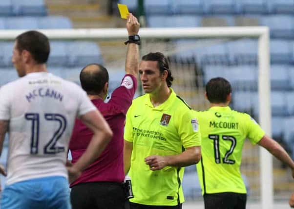 ADDING UP - John-Joe O'Toole is booked at Coventry in August, one of 12 yellow cards he has received this season