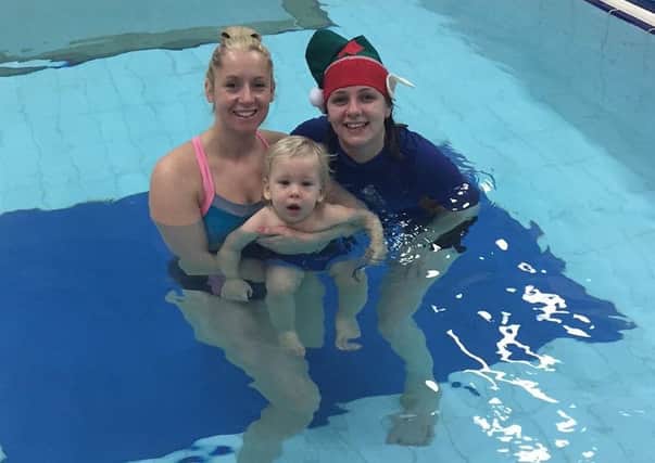 Katy Brown with her one-year-old son Jackson and Water Babies swimming teacher Emma Hardinges