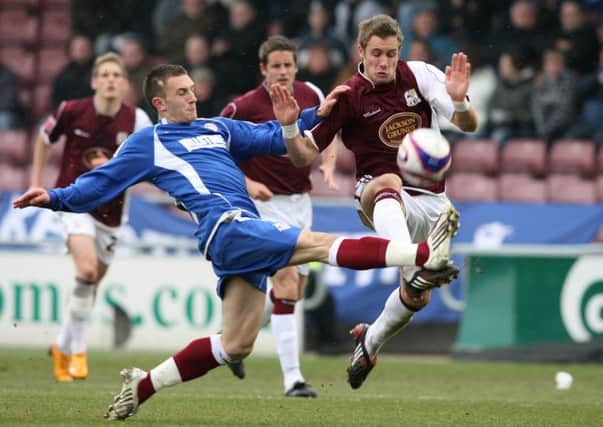 FLASHBACK - Neal Eardley, then of Oldham Athletic, tackles the Cobblers' Ryan Gilligan at Sixfields in 2008 (Picture: Pete Norton)