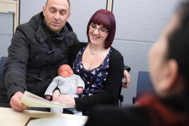 Northamptonshire Registration Service at Central Library, Abington Street, Northampton. From left Paul Blair, Noah Blair and Emma Coles.