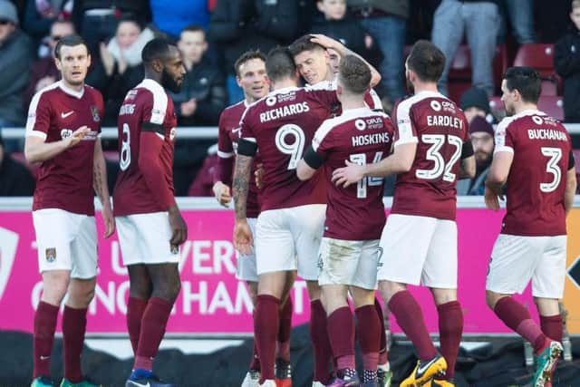 SMART ALEX - the Cobblers players celebrate Alex Revell's first-half equaliser (Pictures: Kirsty Edmonds)