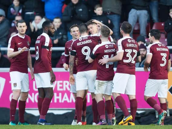 SMART ALEX - the Cobblers players celebrate Alex Revell's first-half equaliser (Pictures: Kirsty Edmonds)