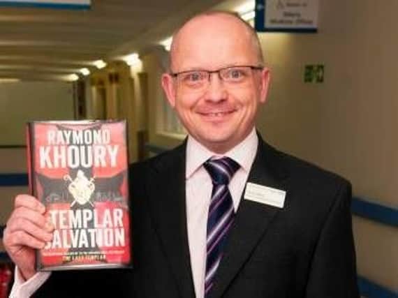 NGH director of strategy and partnerships Chris Pallot with his donated book