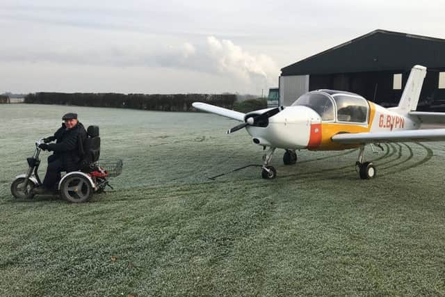 David Bell, retired farmer and active pilot with Muscular Dystrophy, manoeuvres one of his light aircraft with the assistance of his TGA Supersport mobility scooter.