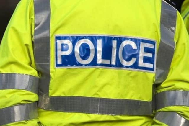 The three robbers pulled their victim into the road before making off with her handbag.