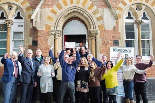Northampton Becket Rotary Club and the staff of The Lowdown give a cheer outside the offices.