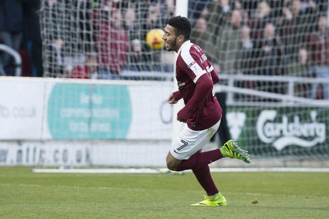 OFF AND RUNNING: Keshi Anderson wheels away in celebration after slotting Cobblers ahead