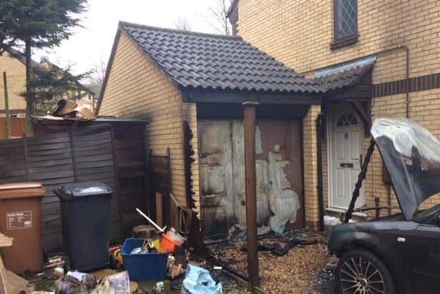 Fire crews were called to the scene at 5.55am where two cars and the garage door were ablaze.