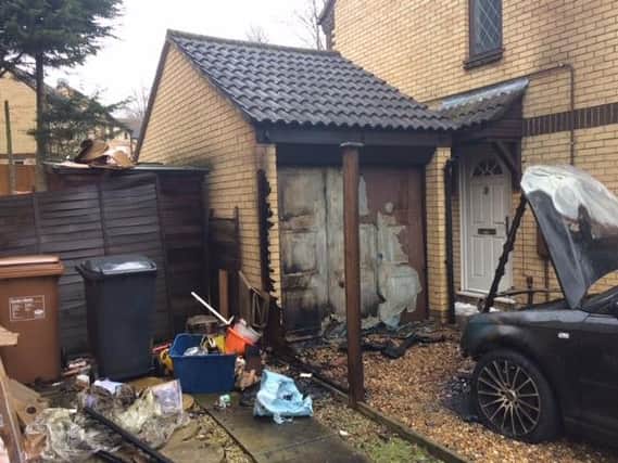 Fire crews were called to the scene at 5.55am where two cars and the garage door were ablaze.
