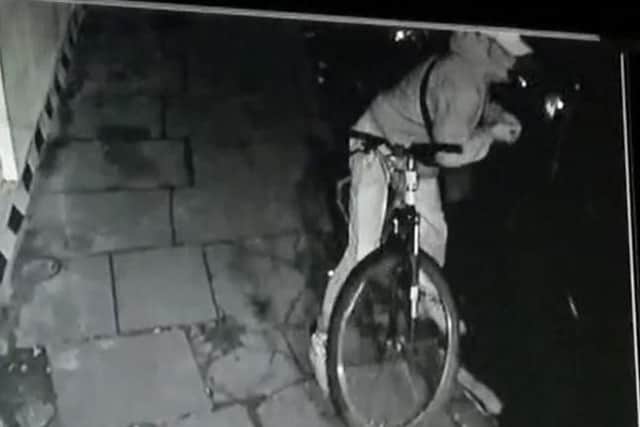 CCTV footage of a thief smashing a car window before he reaches into the car, grabs a handbag and makes a getaway on his pushbike.